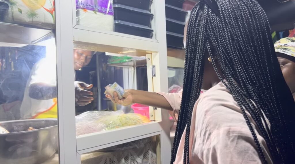 things to see and do in Ghana - Osu night market buying waakye