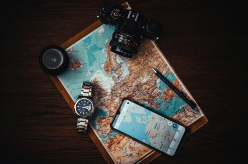 smartphone beside watch and camera