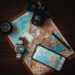 smartphone beside watch and camera